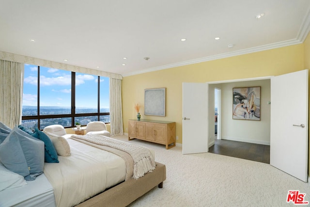 bedroom with a water view, crown molding, and carpet