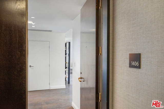 corridor featuring hardwood / wood-style floors