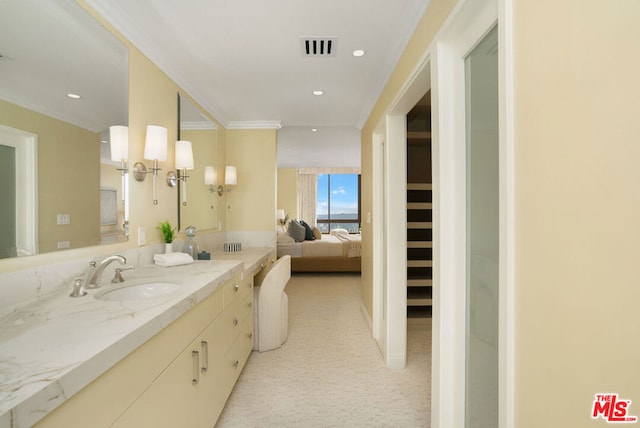 bathroom featuring crown molding and sink