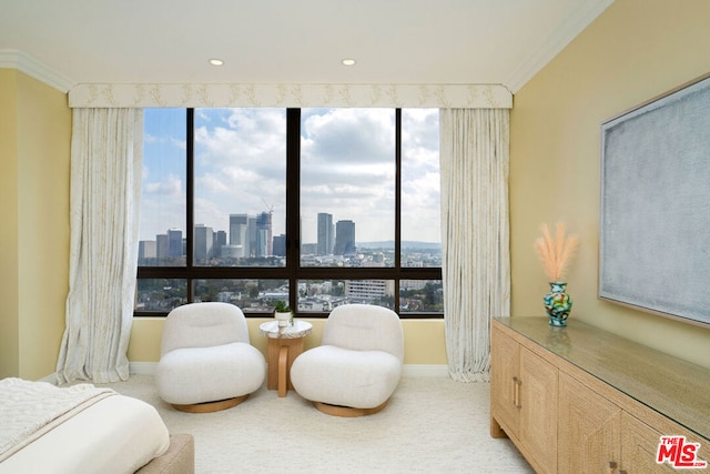 living area featuring ornamental molding and light carpet