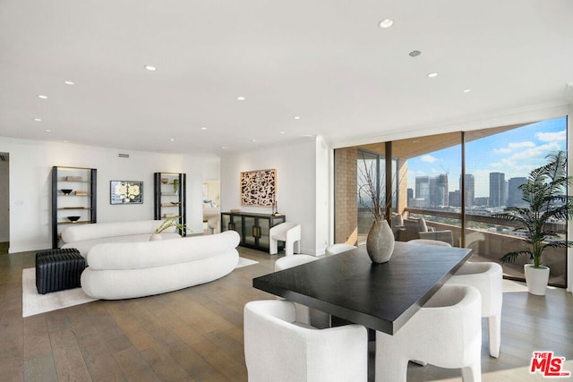 interior space with wood-type flooring, ornamental molding, and expansive windows