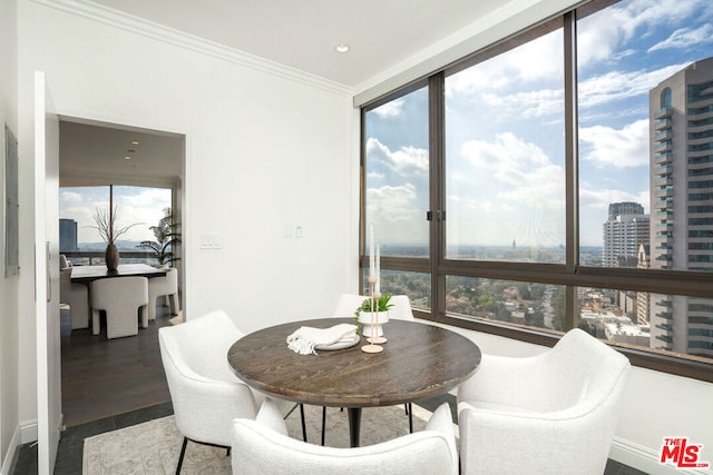 dining area featuring ornamental molding and dark hardwood / wood-style floors