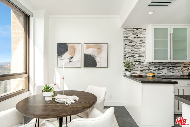 dining area featuring crown molding