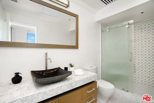 bathroom with vanity, crown molding, toilet, and walk in shower