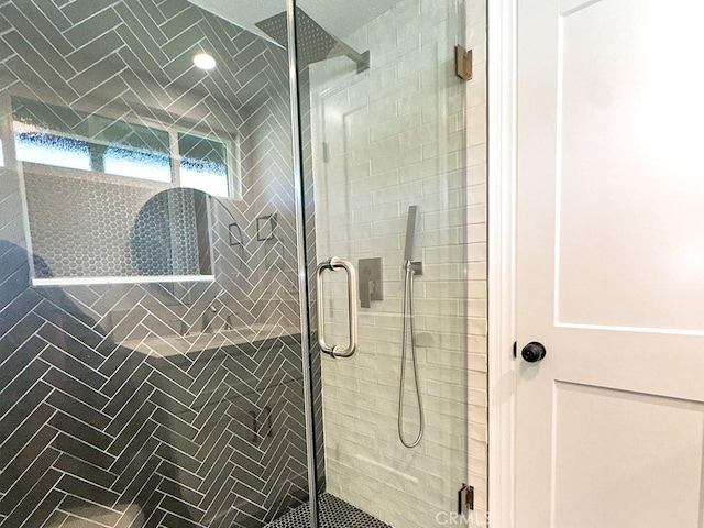 bathroom featuring a shower with door