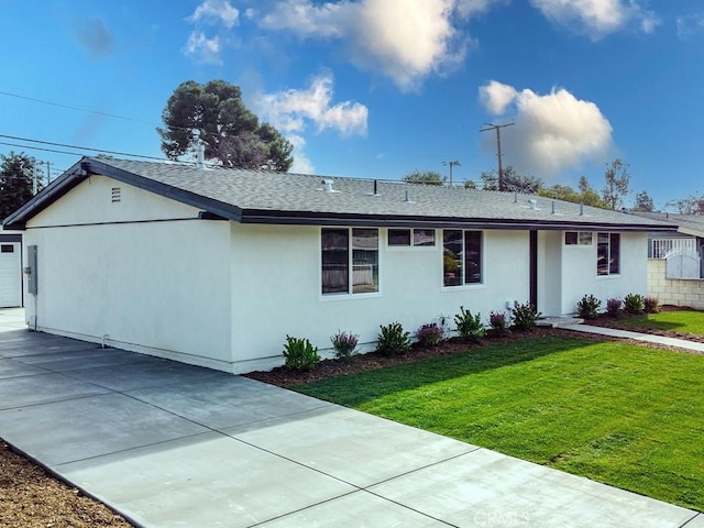 single story home featuring a garage and a front yard