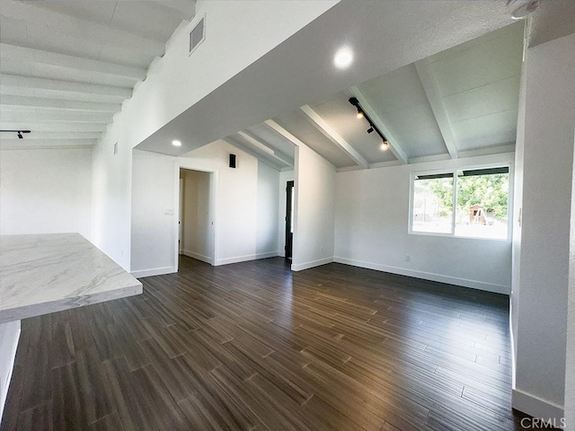 unfurnished room with dark hardwood / wood-style flooring and lofted ceiling with beams