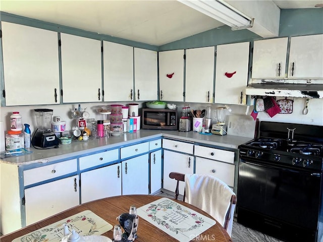 kitchen featuring black gas range oven and white cabinets