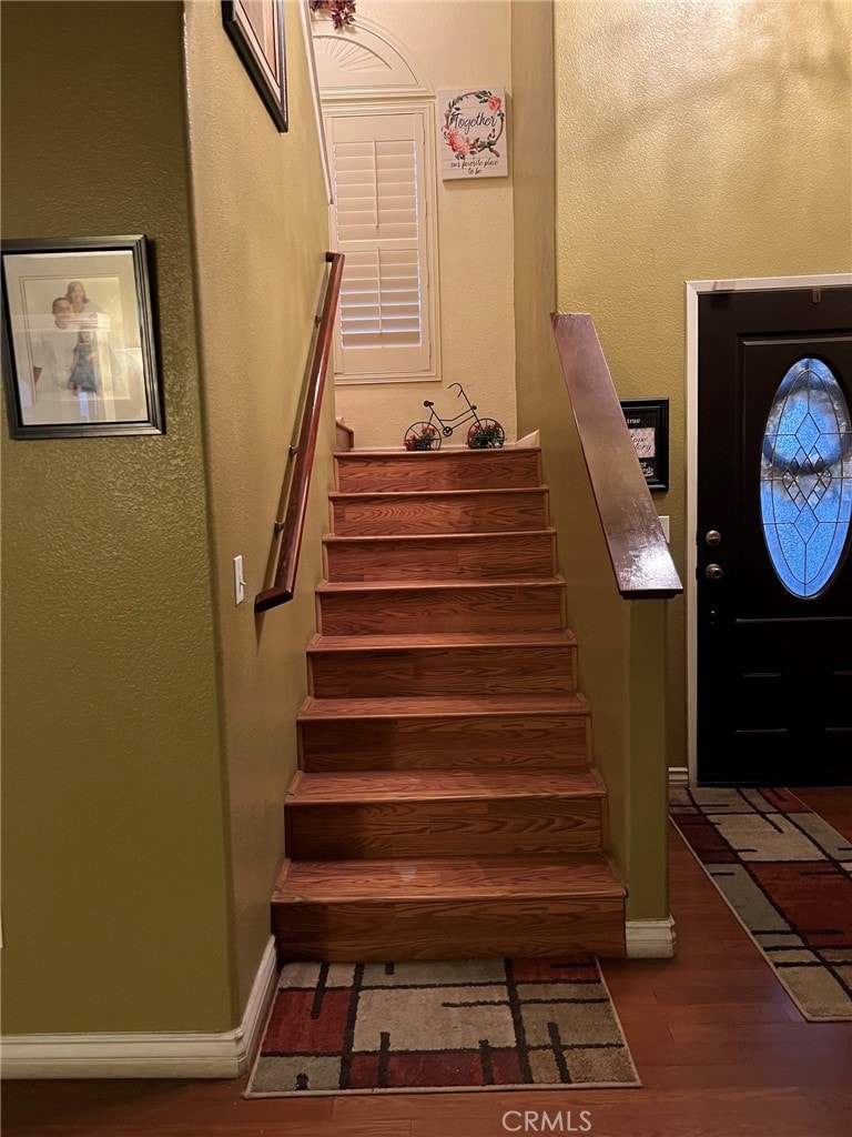 stairway with hardwood / wood-style flooring