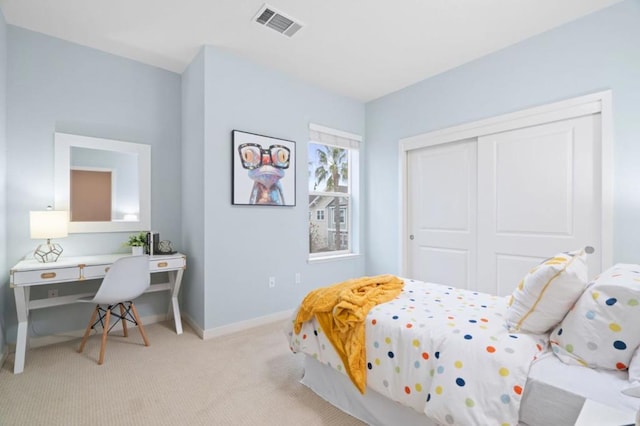 bedroom with light carpet and a closet