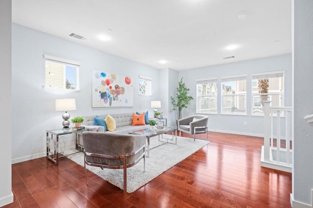 living room featuring plenty of natural light and dark hardwood / wood-style floors