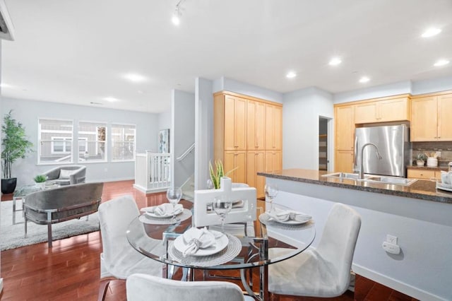 dining space featuring dark hardwood / wood-style flooring and sink