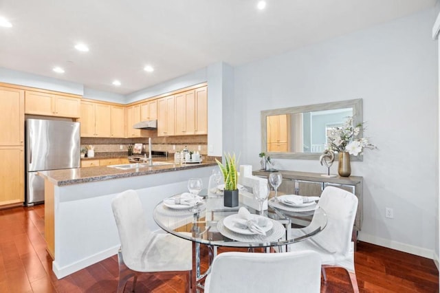 dining space featuring dark hardwood / wood-style flooring and sink