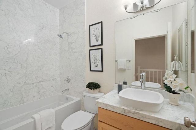 full bathroom featuring tiled shower / bath combo, vanity, and toilet