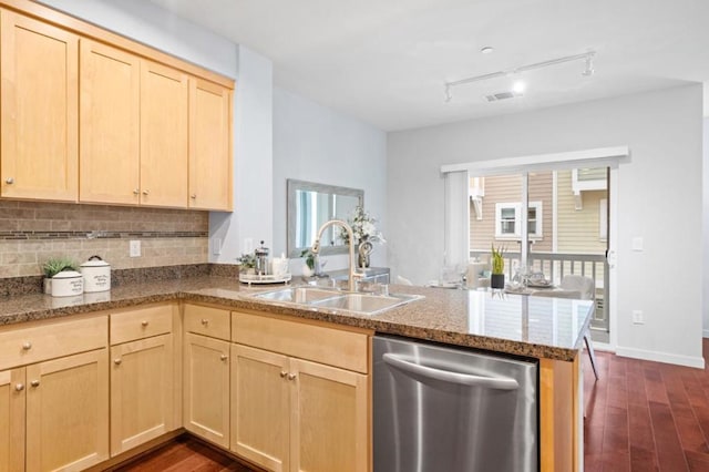 kitchen featuring dishwasher, sink, dark hardwood / wood-style flooring, decorative backsplash, and kitchen peninsula