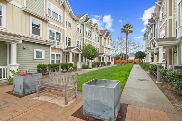 view of community featuring a yard and a patio