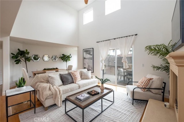 living room with a high ceiling and hardwood / wood-style floors