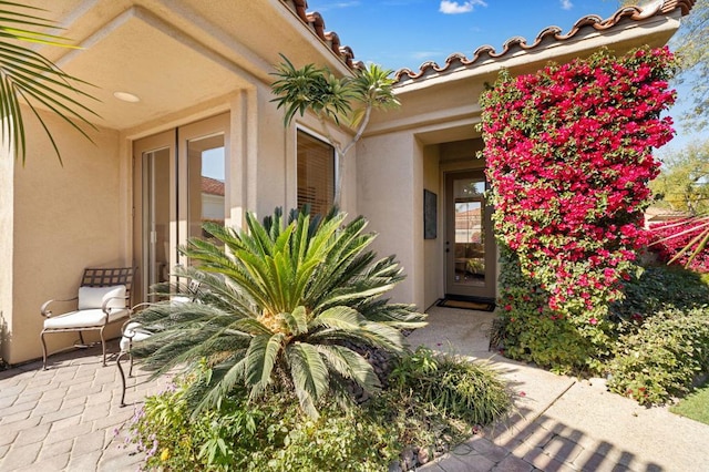 doorway to property with a patio area