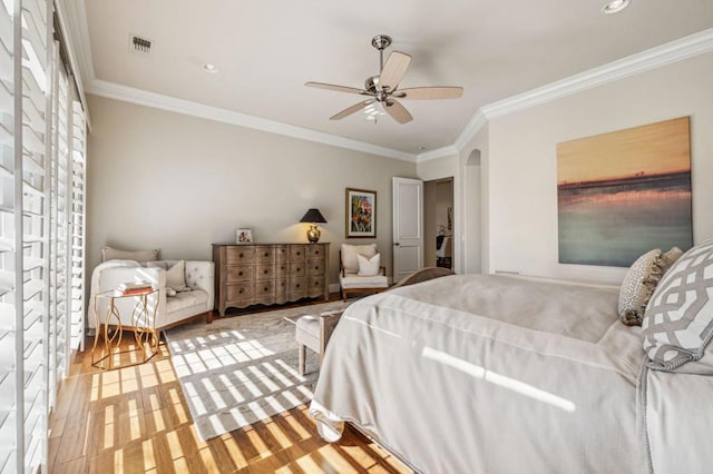 bedroom with ceiling fan, ornamental molding, and light hardwood / wood-style flooring