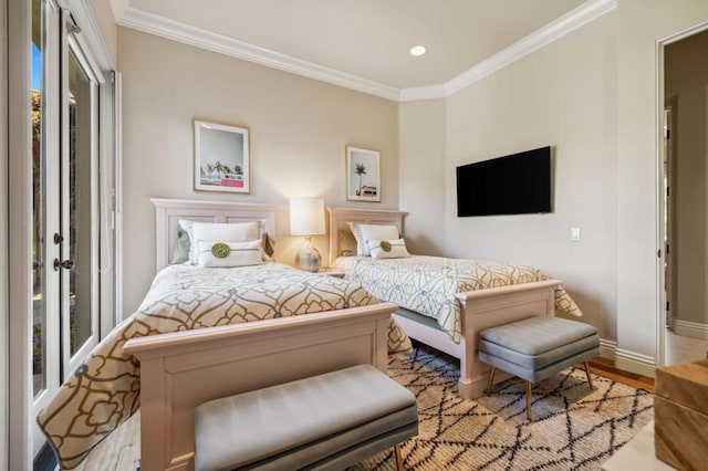 bedroom featuring crown molding and light hardwood / wood-style floors