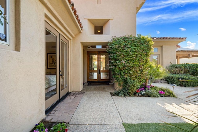 view of exterior entry featuring french doors