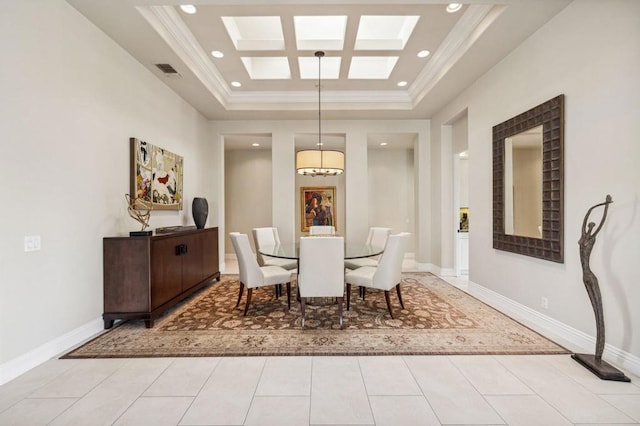 tiled dining room featuring crown molding and a raised ceiling