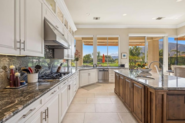 kitchen featuring white cabinetry, appliances with stainless steel finishes, sink, and dark stone counters