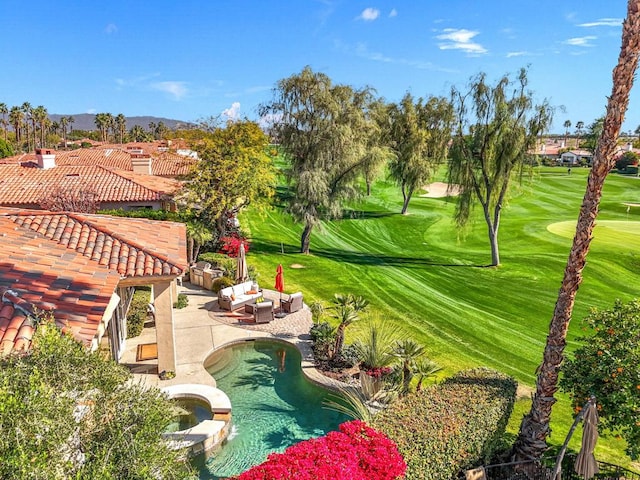 view of community featuring an outdoor hangout area, a jacuzzi, and a patio area