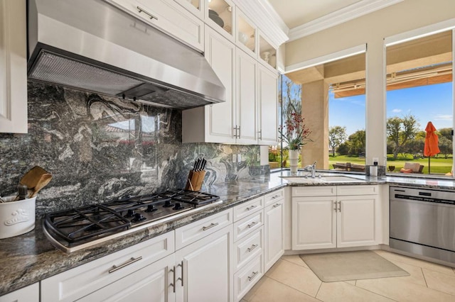 kitchen featuring white cabinetry, sink, dark stone counters, ornamental molding, and stainless steel appliances