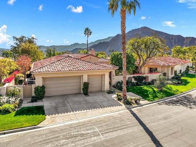 mediterranean / spanish-style house featuring a garage and a mountain view