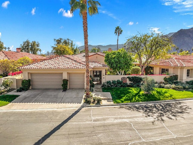 mediterranean / spanish-style home featuring a garage and a mountain view