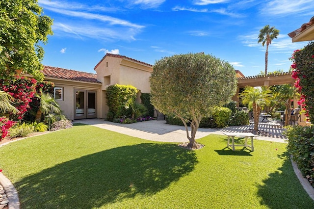 back of property featuring a pergola, a yard, a patio, and french doors