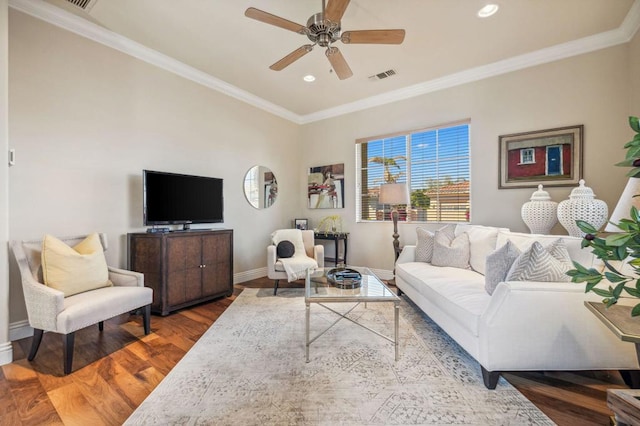 living room with hardwood / wood-style flooring, ceiling fan, and crown molding