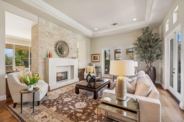 living room featuring crown molding and light hardwood / wood-style flooring