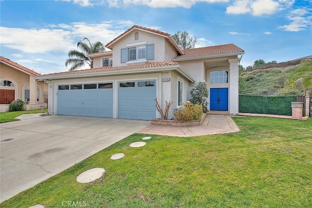 mediterranean / spanish-style home with a garage and a front lawn