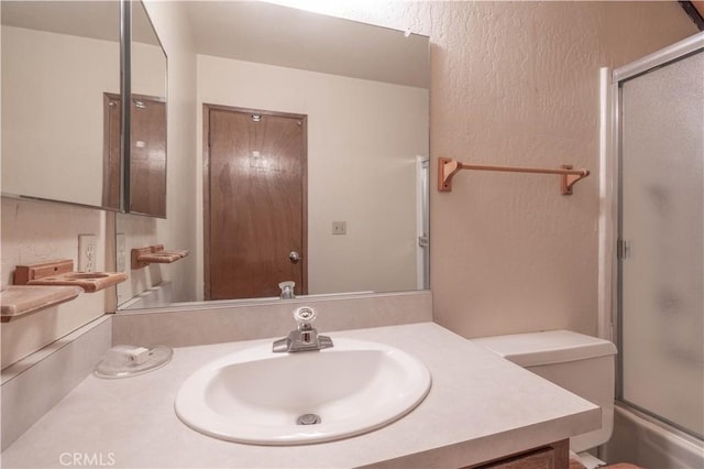 bathroom featuring vanity and shower / bath combination with glass door