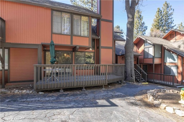 back of property with a wooden deck