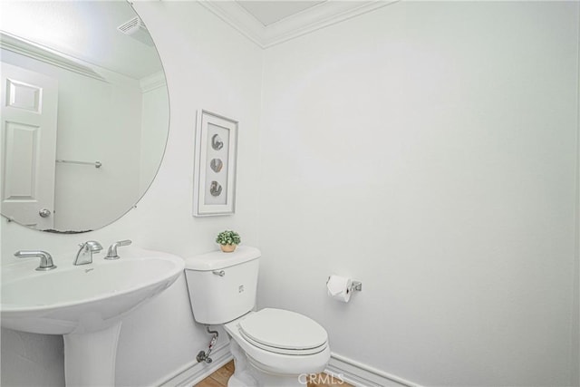 bathroom featuring sink, wood-type flooring, ornamental molding, and toilet