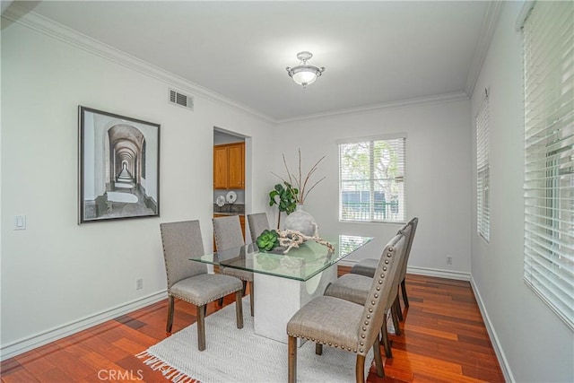 dining space featuring crown molding and dark hardwood / wood-style floors