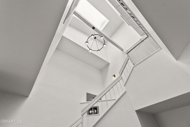 interior details with a skylight and a notable chandelier