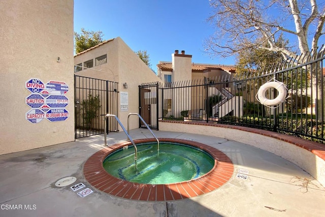 view of pool featuring a hot tub