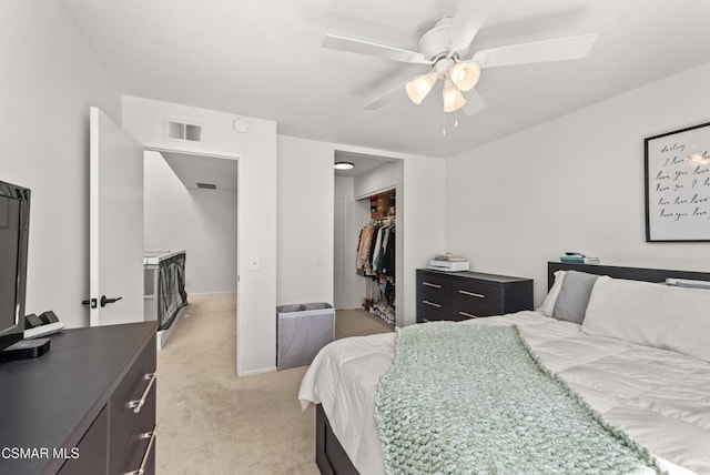 bedroom with light colored carpet, a closet, and ceiling fan