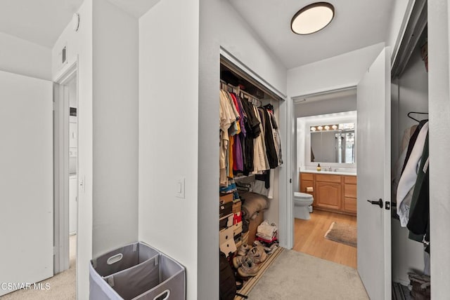 spacious closet with light hardwood / wood-style floors