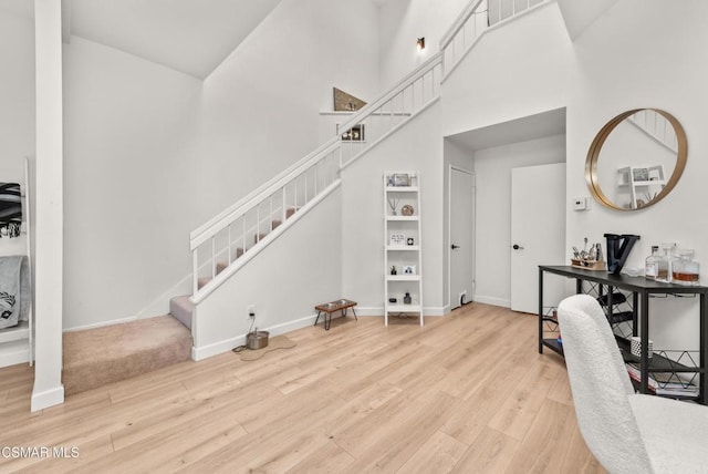 office featuring a high ceiling and wood-type flooring