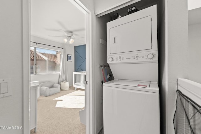 laundry room with stacked washer and clothes dryer, ceiling fan, and carpet