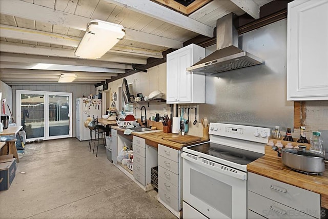 kitchen featuring butcher block counters, island range hood, white appliances, and white cabinetry