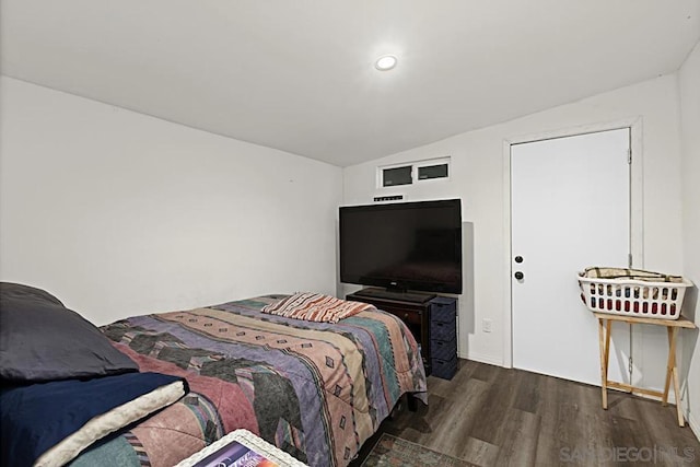 bedroom featuring lofted ceiling and dark hardwood / wood-style flooring