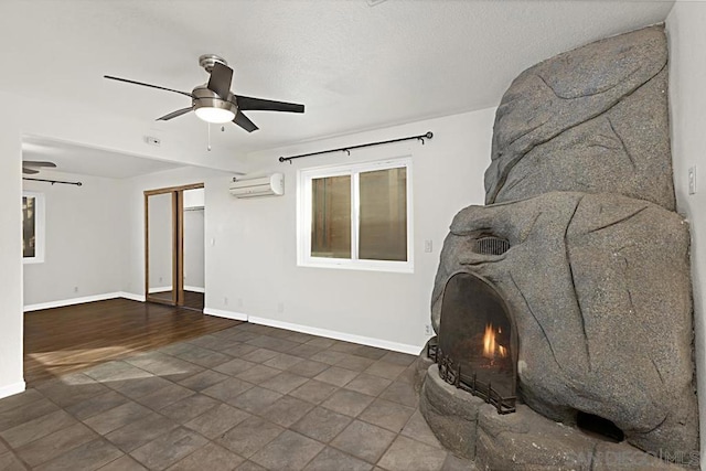 living room with ceiling fan and a wall unit AC