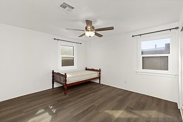 unfurnished bedroom featuring dark hardwood / wood-style floors and ceiling fan