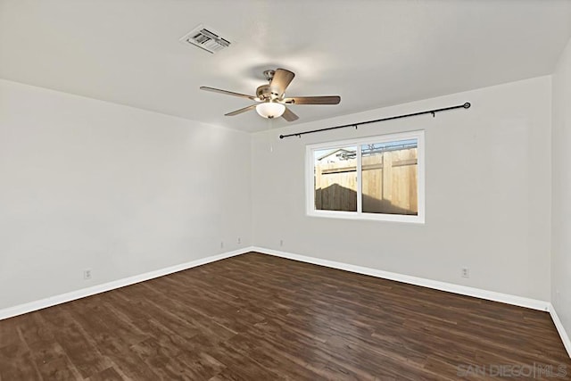 spare room with ceiling fan and dark hardwood / wood-style flooring